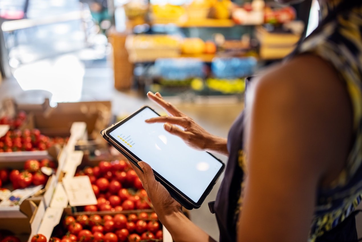 Person using tablet in grocery store