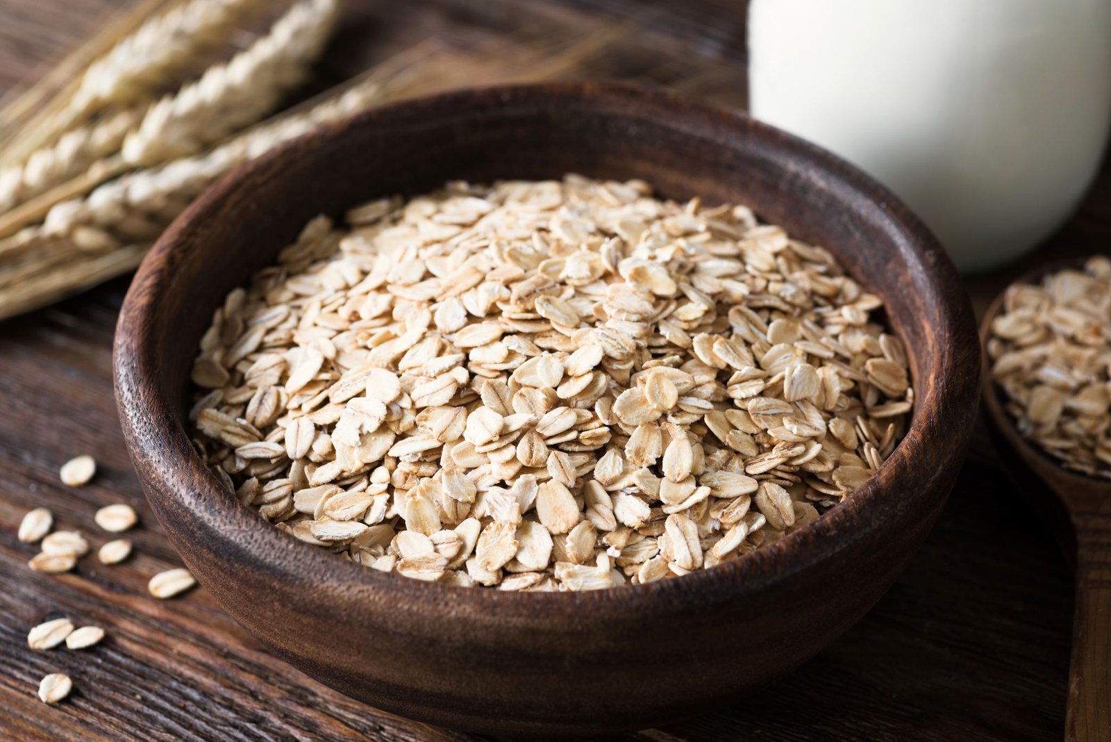 Rolled oats in wooden bowl and table