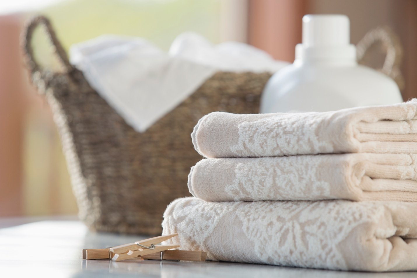 A basket, wooden clips, and cloth on a table