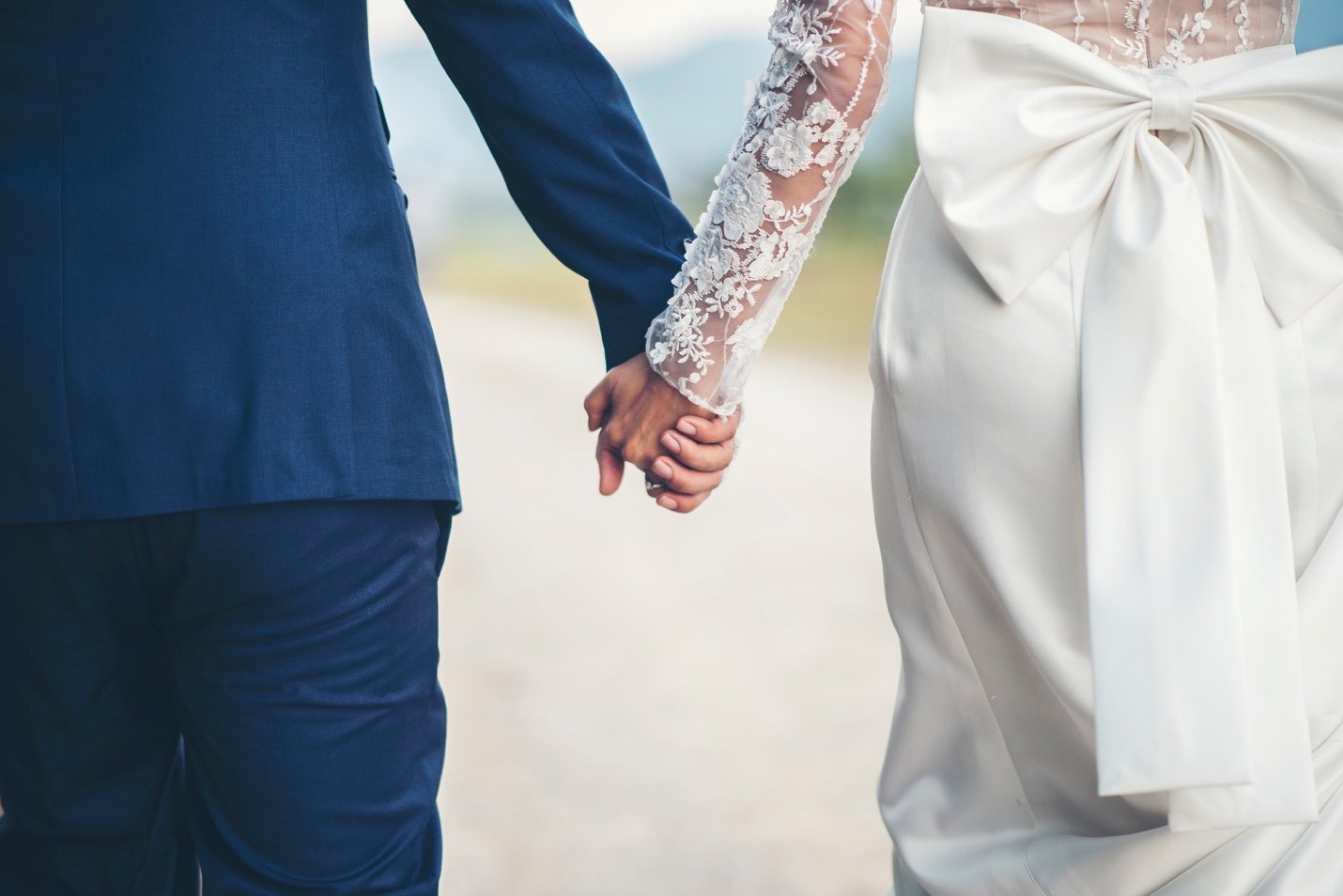 Couple holding hands on their wedding day